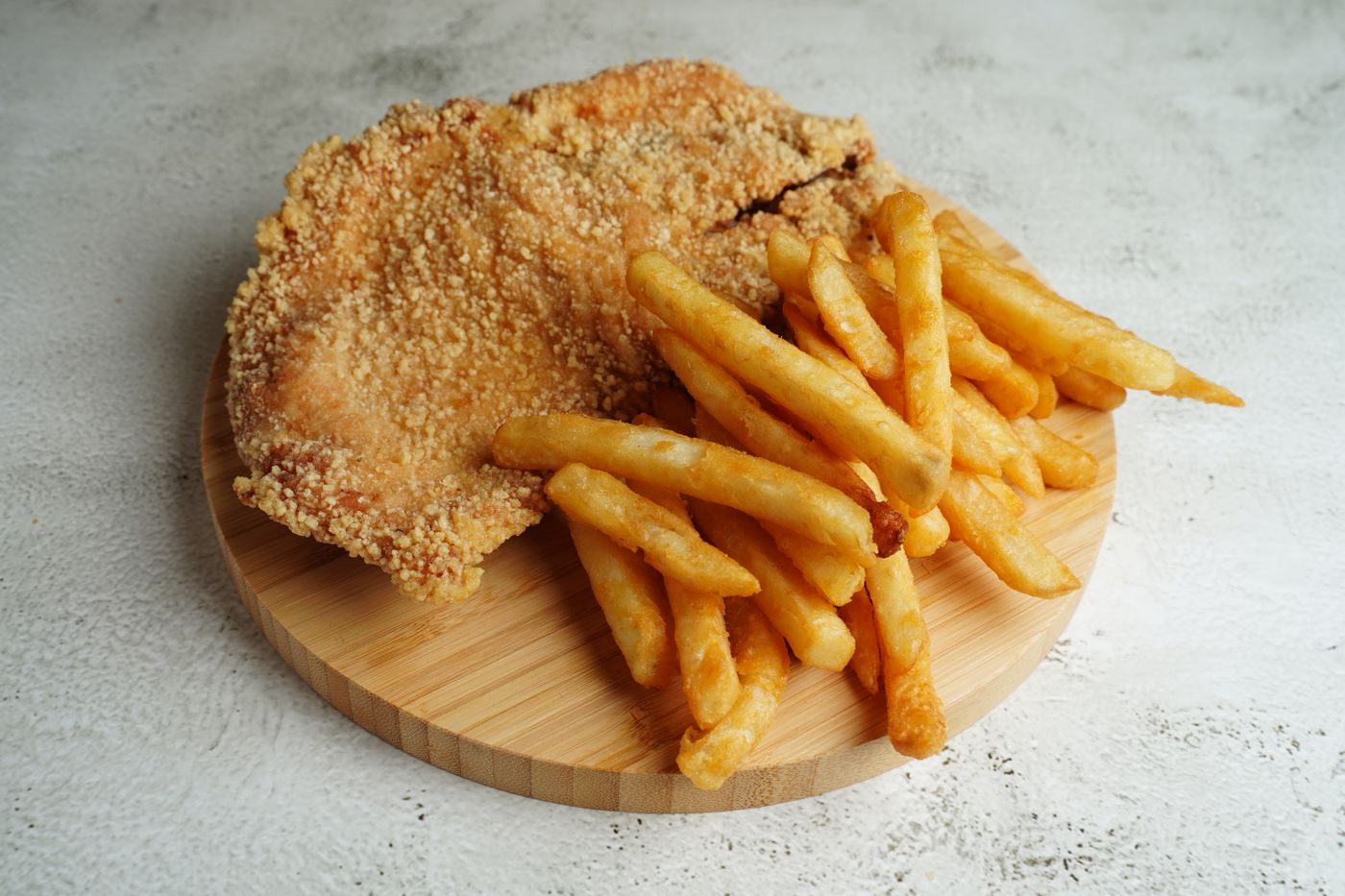 Crispy chicken schnitzel served with hot chips